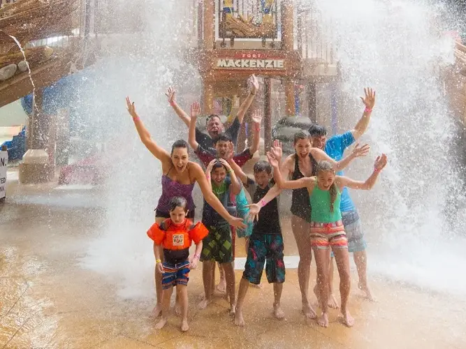 A group of people standing in front of a fountain